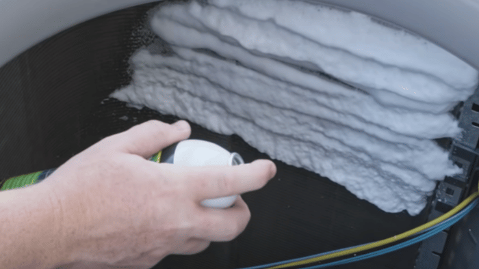 Clearing debris from an outdoor air conditioning condenser