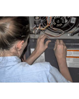 Tech doing a furnace inspection